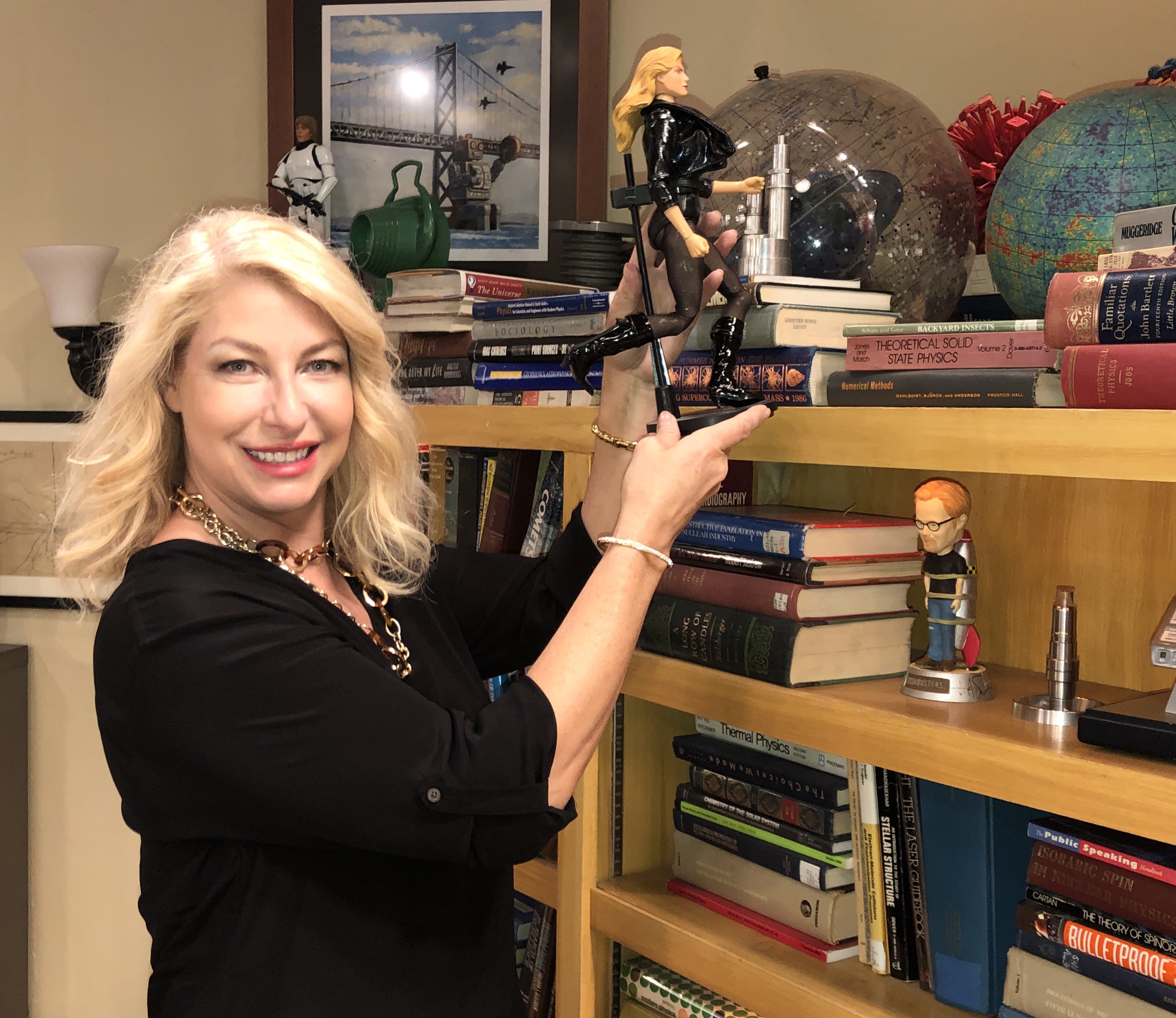 Ann Shea displaying a prop from the Big Bang Theory living room scene