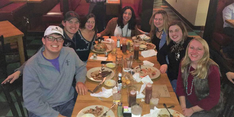 Maggie Sweppy and a group of friends at a table after eating dinner