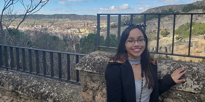 Daniela standing at a ledge with a view while in Spain