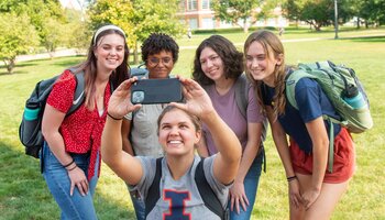 Group of students outside taking a selfie.