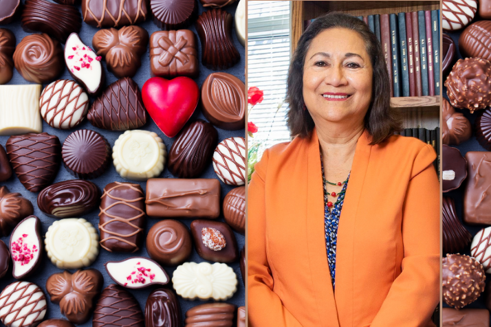 Professor Elvira de Mejia's poses for a picture. Valentine's Day chocolates are displayed beside her headshot