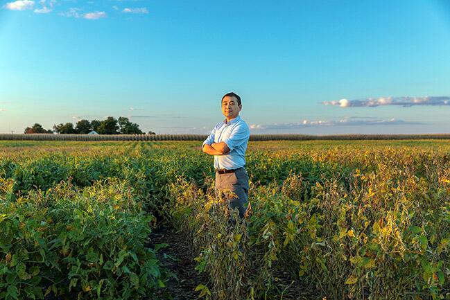 Kaiyu Guan standing in a field