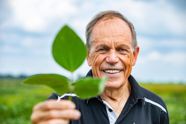 Steve Long holding soybean leaf