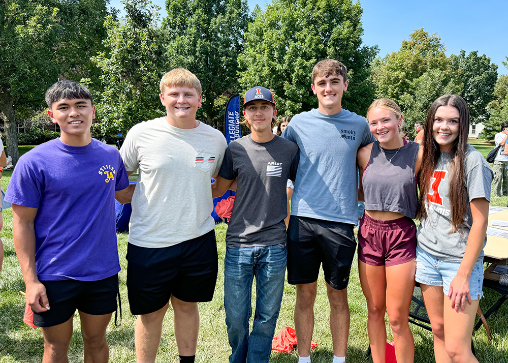 A group of six students standing outside at an ACES event.