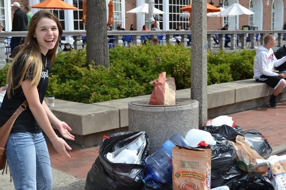 Maddy Liberman next to pile of trash on campus 