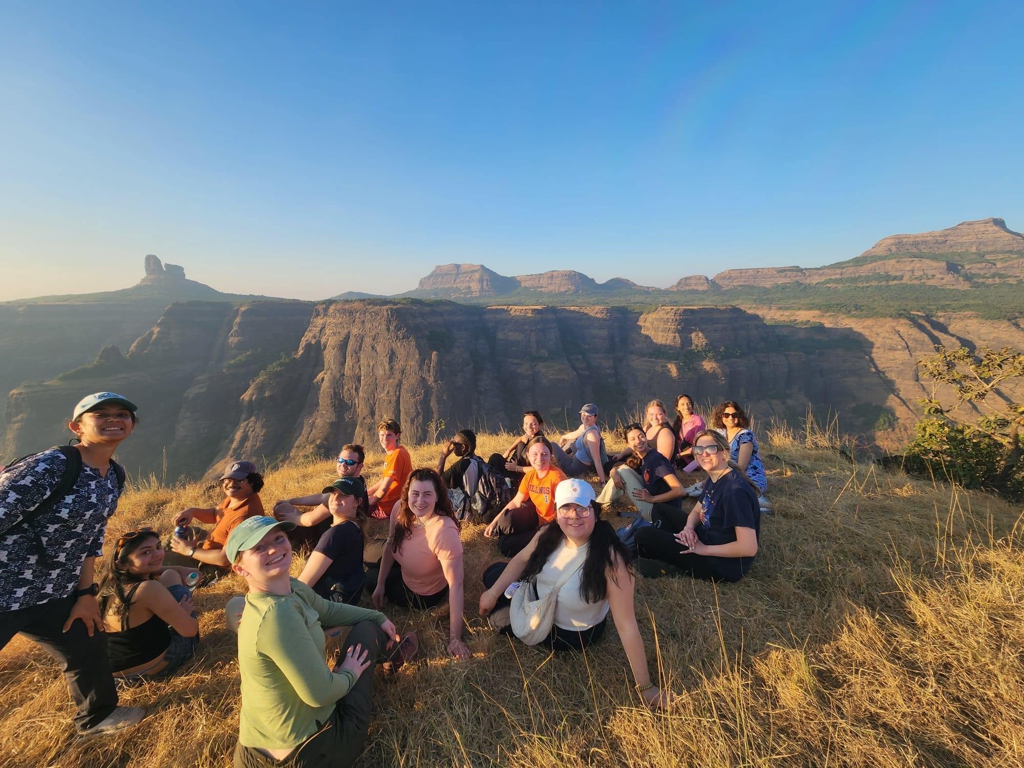 Students sitting on a mountain in India
