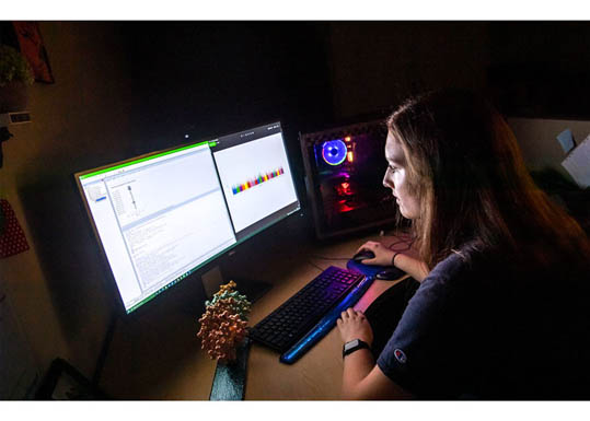 Student working on data at a computer