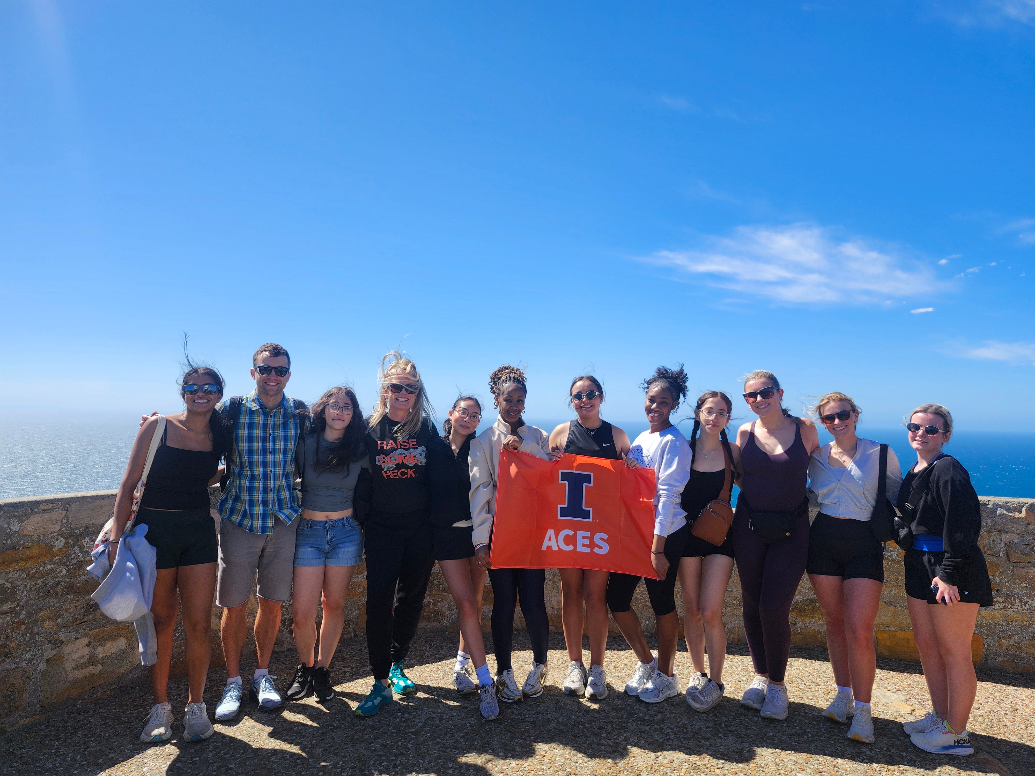 Students standing in group with ACES flag