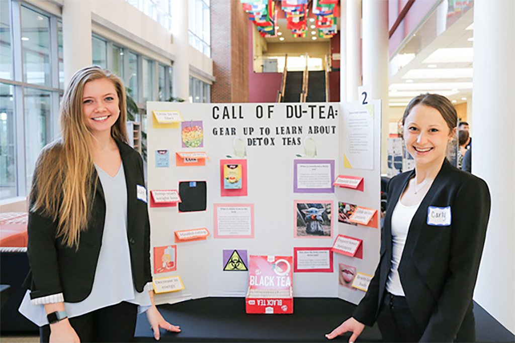 Students in front of a poster