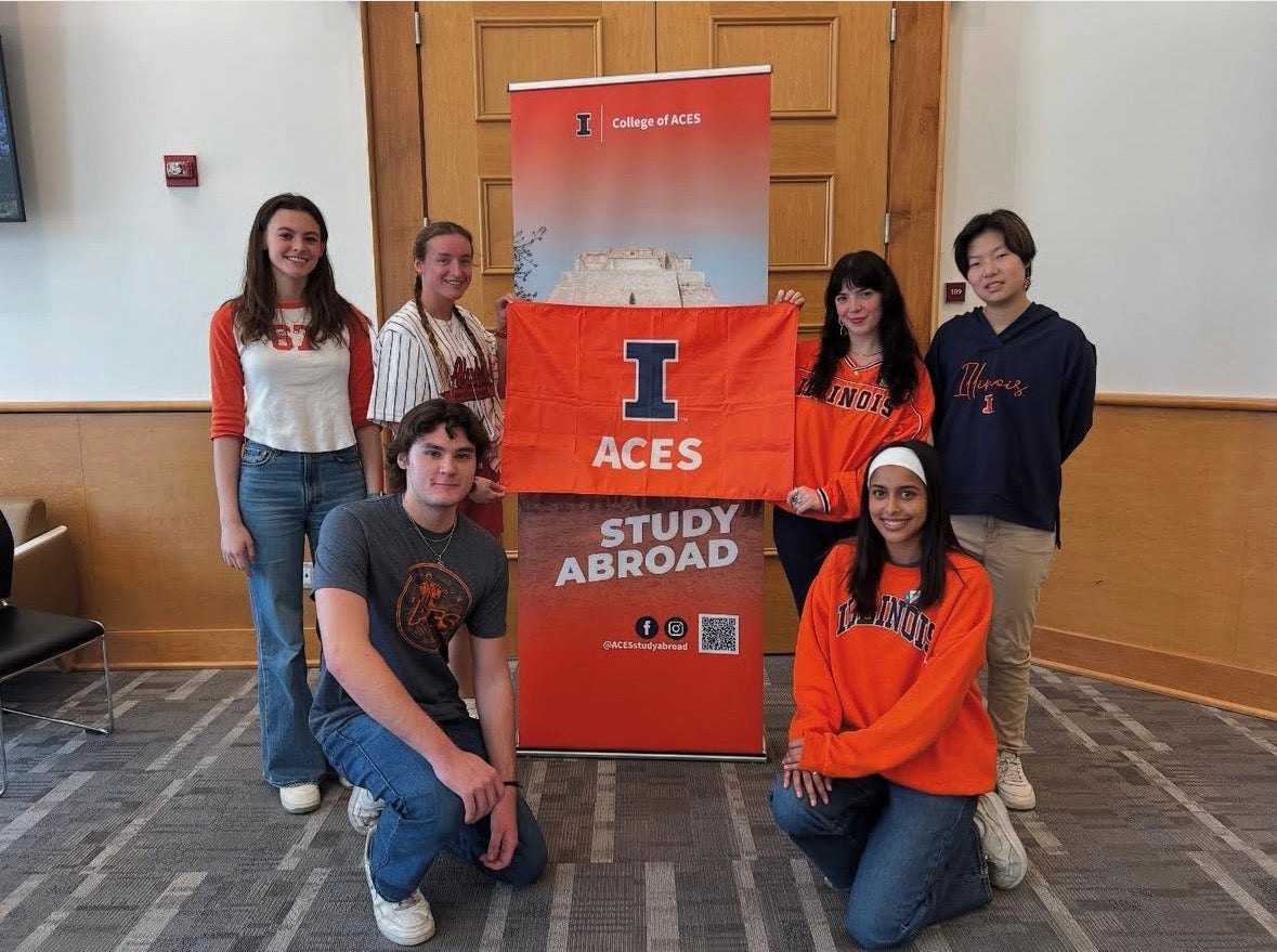 Students in front of study abroad sign