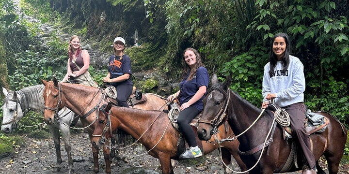 Four students on horses in Colombia