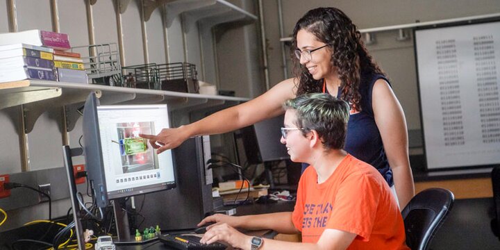 Instructor working with a student on a computer