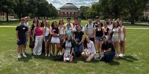 Group of exchange students on the main quad with Foellinger Auditorium in the background. 