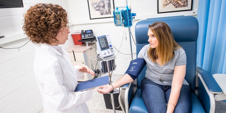 Students taking blood pressure in lab.