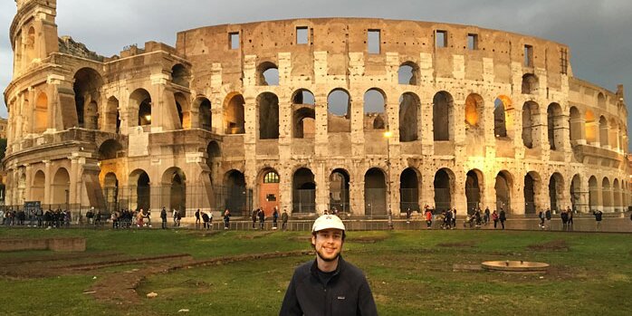 ACES student in front of the colosseum in Rome