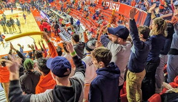 Students at a basketball game for the fighting illini