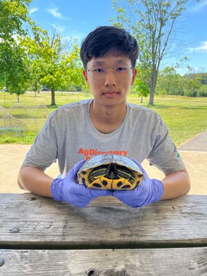 Student holding a turtle.