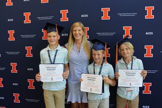 family with graduation certificates