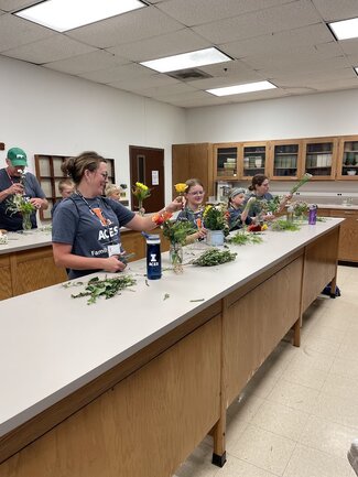 a group participating in floral arranging