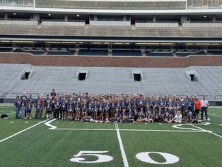 a group photo on memorial stadium's field