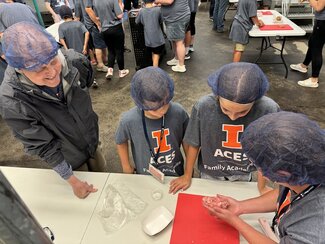 a family learning how to shape a sausage patty