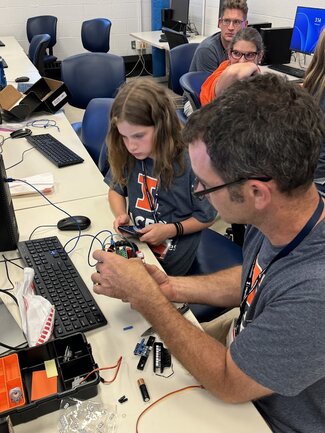 a family putting together a robot