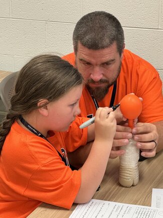 a family crafting a balloon project