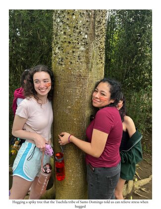Two people smile while hugging a large spiky tree, which the caption notes is part of a stress-relief tradition shared by the Tsachila tribe of Santo Domingo.
