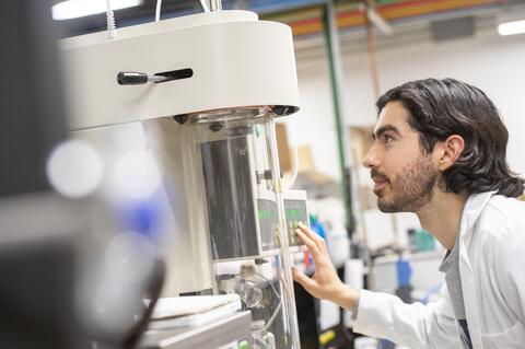 Student examining a piece of equipment