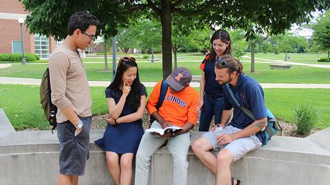 Students gathered around each other talking