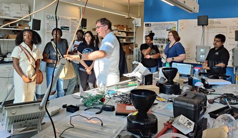 REU students and mentors explore the lab.
