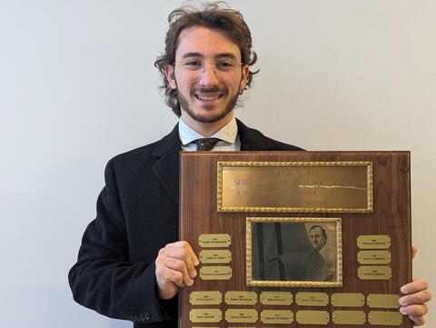 Joshua D’Avola holding plaque