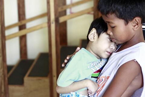 boy helping younger sibling