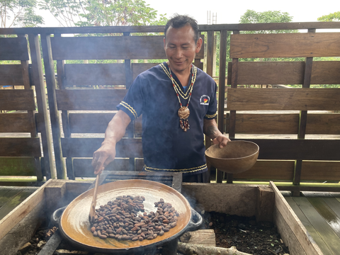 Ecuadorian farmer cooking cocoa beans. 