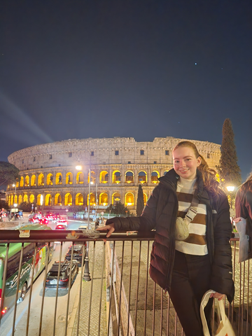 Julia poses in front of the colosseum.