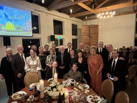 A large group celebrates Jim and Marlene Evans at the gala.