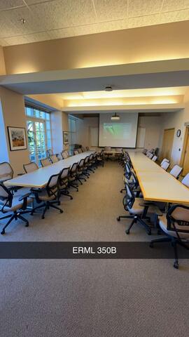 A large conference room, labeled "ERML 350B," is set up with two long tables surrounded by chairs, facing a projector screen at the front of the room.