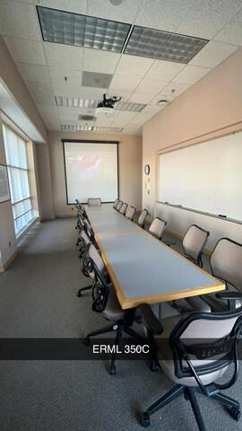 A small conference room, labeled "ERML 350C," features a long table with chairs, a projector screen at the front, and a whiteboard on the side wall.