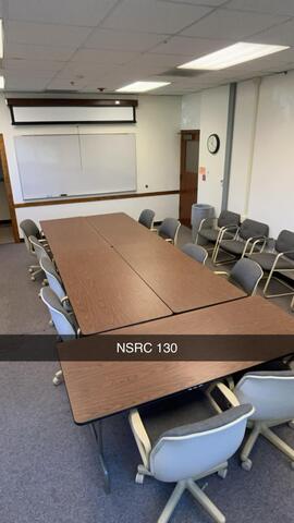 A small conference room, labeled "NSRC 130," is arranged with a rectangular table, several chairs, a whiteboard, and a projector screen at the front.