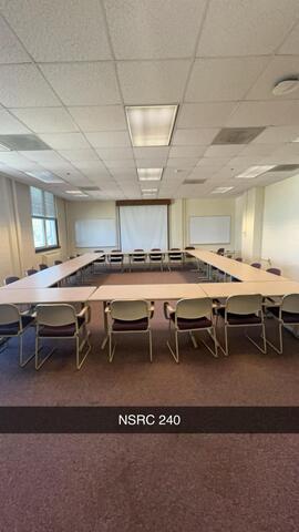 A conference room, labeled "NSRC 240," is arranged with U-shaped tables surrounded by chairs, a projector screen at the front, and whiteboards on the side walls.