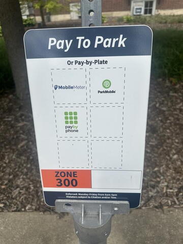 Mobile meter signage that indicates this is a paid visitor parking space