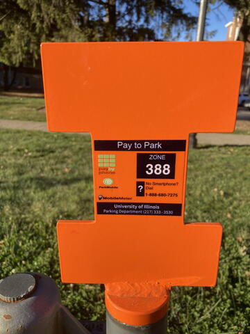 Mobile meter signage that indicates this is a paid visitor parking space