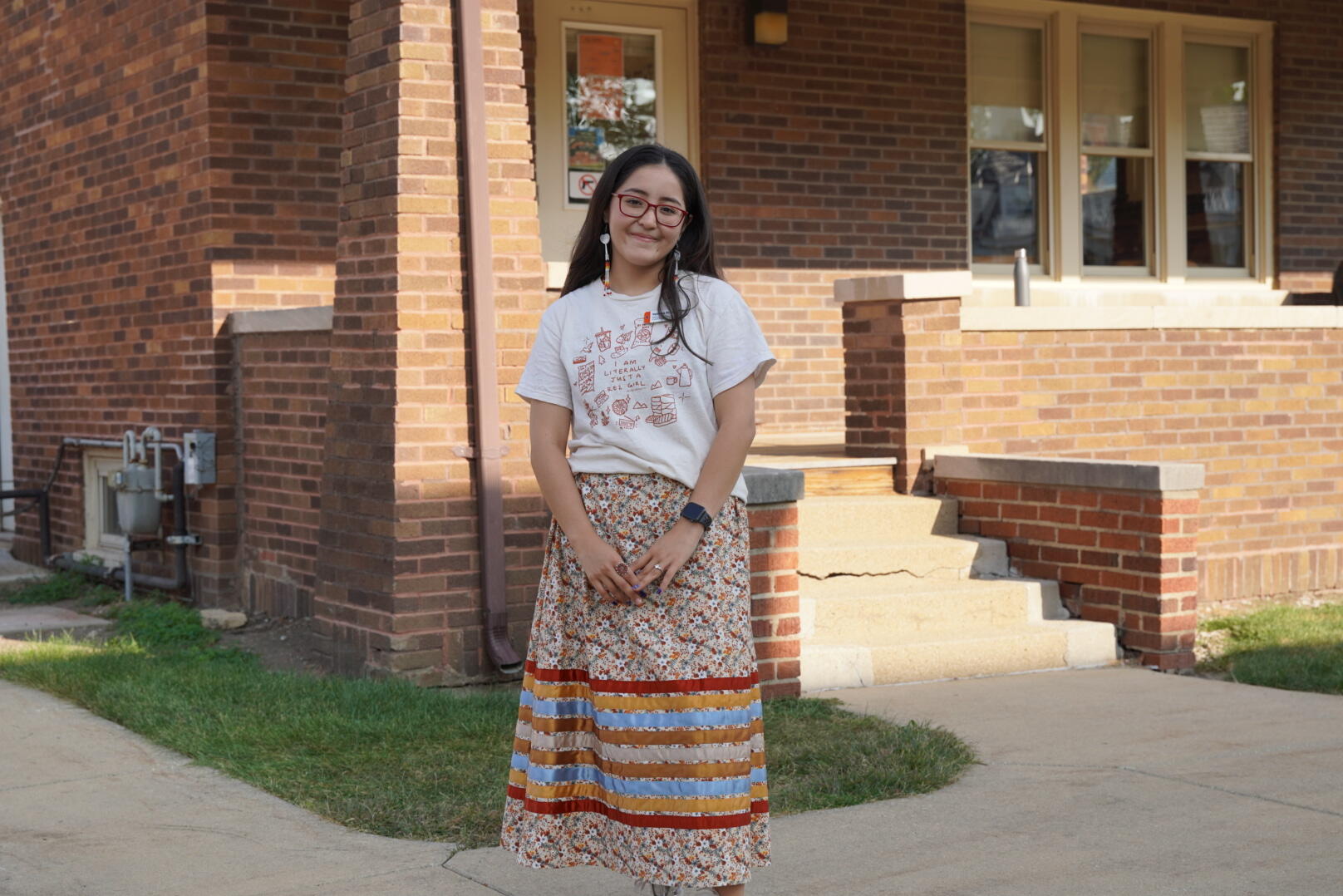 Yanaba Schroeder has served two years as a Native American House Ambassador. Yanaba Schroeder smiling in front of the Native American House.