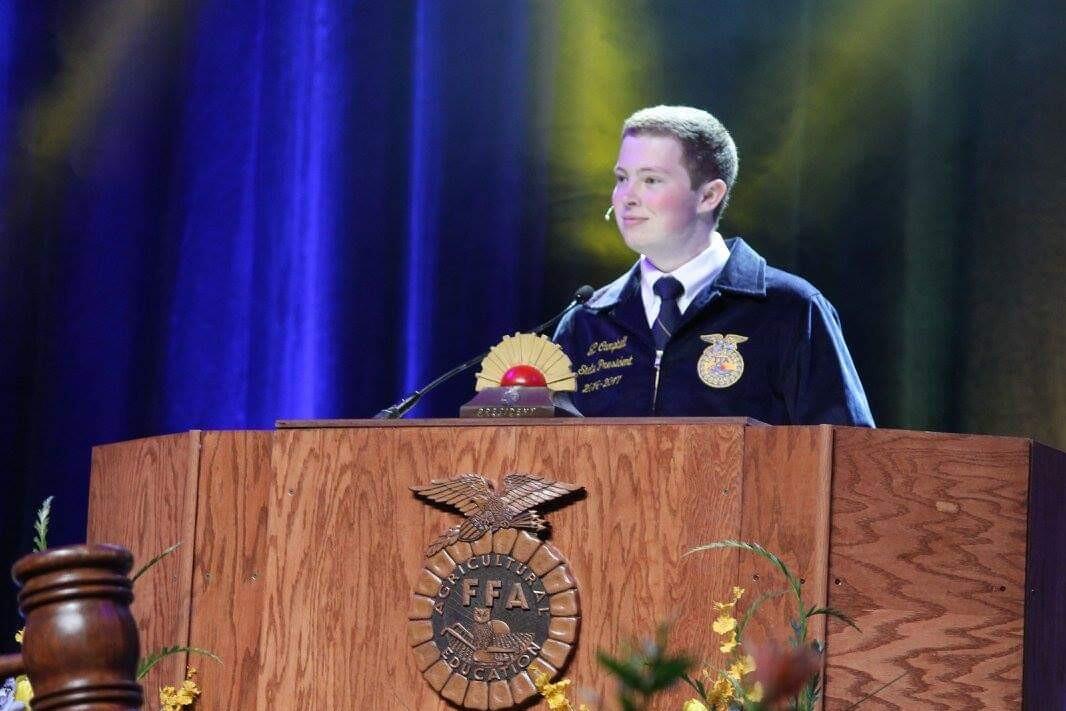 student at podium speaking at FFA conference 