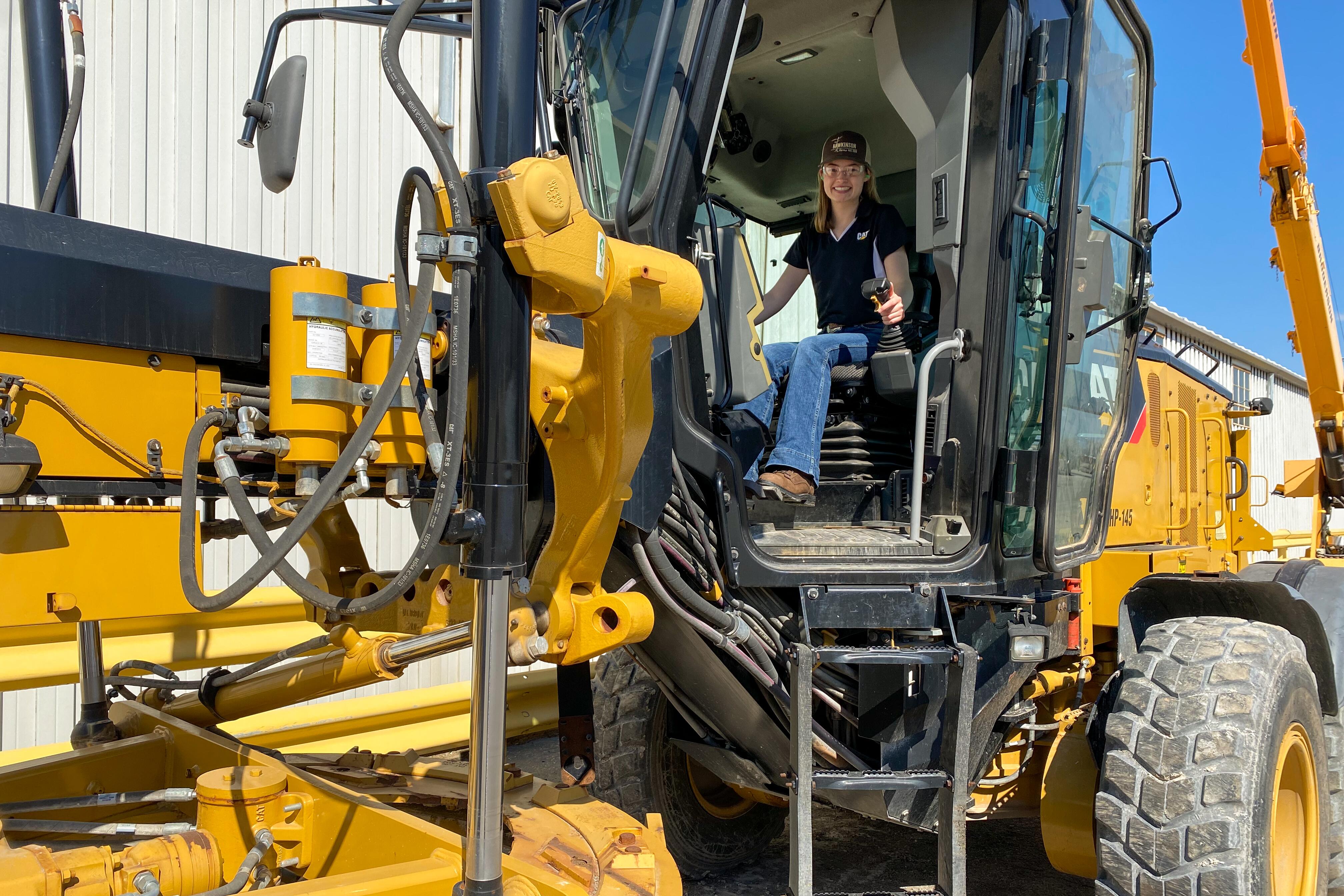 Emma Hawkinson in Caterpillar machinery