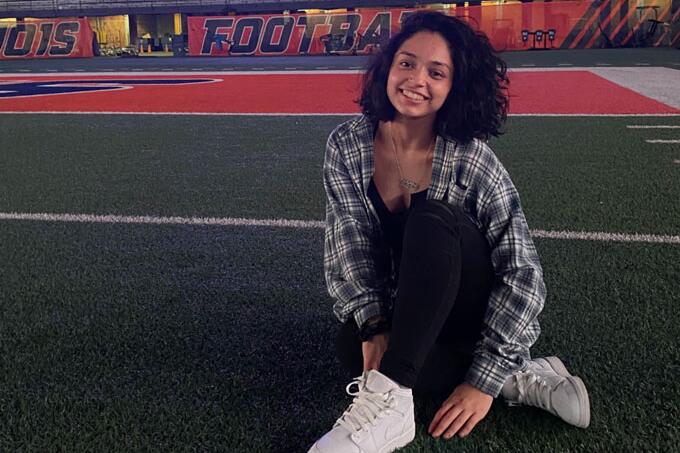 Girl sitting on the Illini Field
