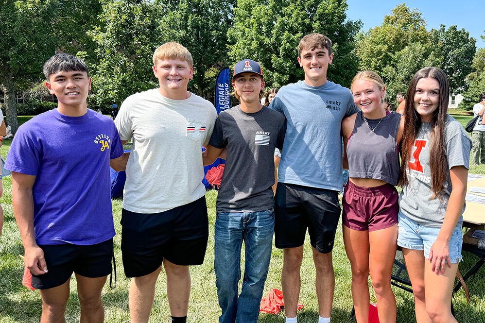 A group of six students standing outside at an ACES event.