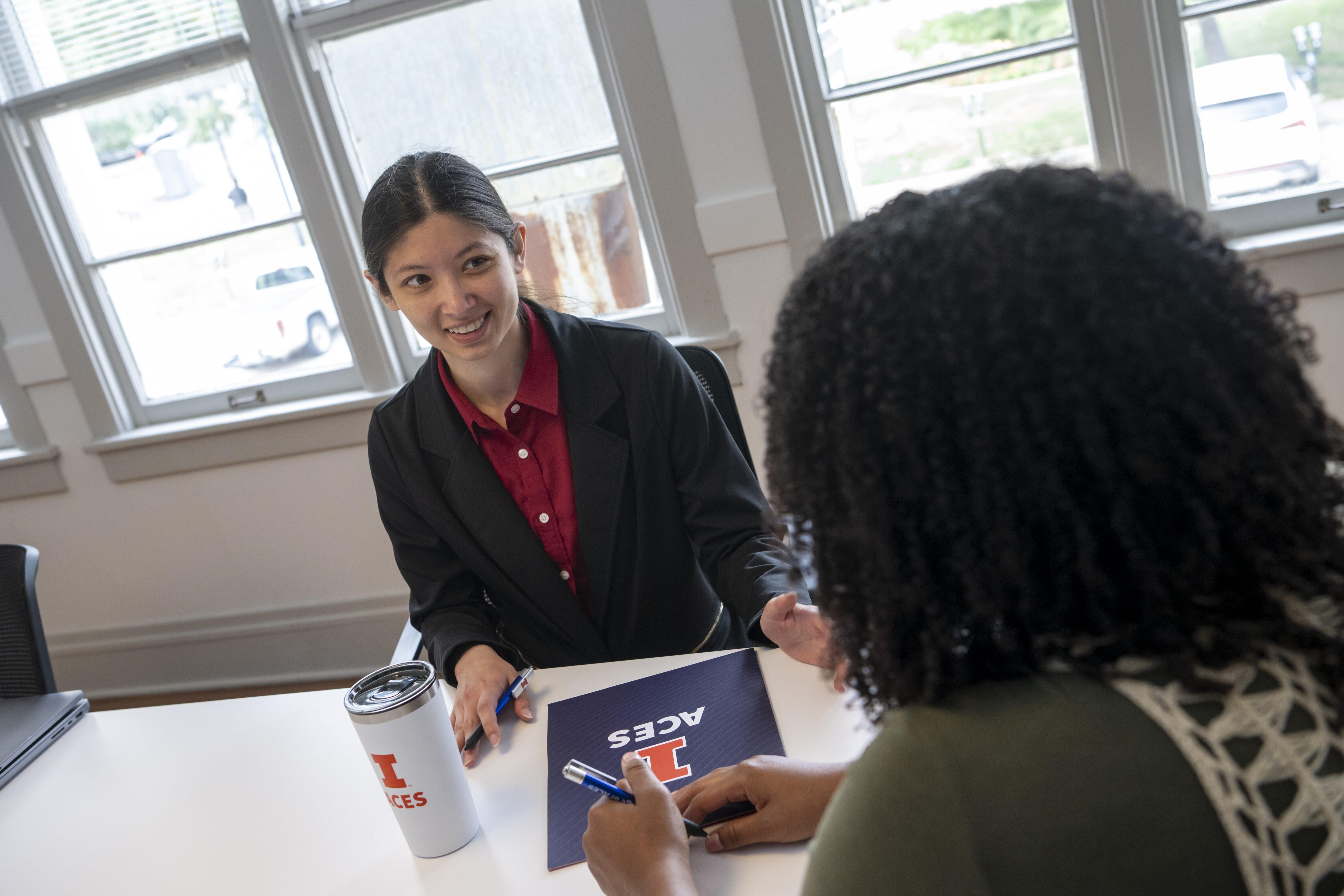 Two women sitting across from each other for a job interview