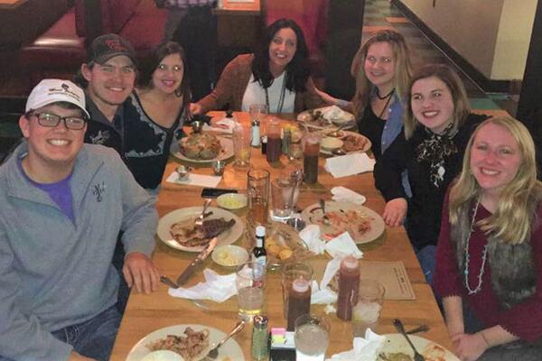 Maggie Sweppy and a group of friends at a table after eating dinner