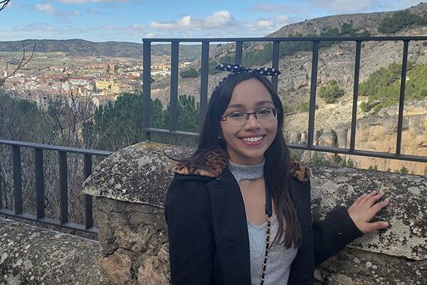 Daniela standing at a ledge with a view while in Spain